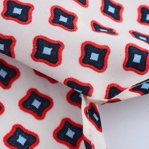 Macro detail of geometric print fabric with fine twill texture and vibrant colors