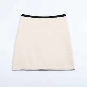 Elegant cream knit A-line mini skirt with contrasting black trim for women's spring style