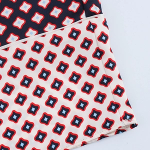 Detail of geometric pattern on women's satin fabric with clean hem stitching