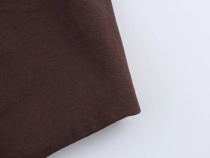 Close-up of dark brown twill fabric texture showing durable cotton blend material