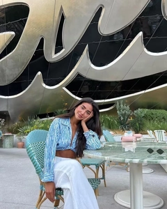 Detail of blue and white striped crop shirt with tie-front design for beach vacation style