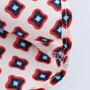 Macro detail of twill fabric shirt showing high-quality stitching and geometric print