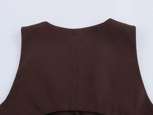 Detail shot of deep brown woven fabric vest showing back neckline and stitching
