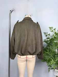 Detail view of the back of a vintage olive green suede bomber jacket with elastic hem