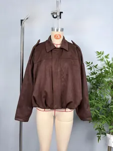 Close-up of brown faux suede bomber jacket with shoulder tabs and elastic hem detailing