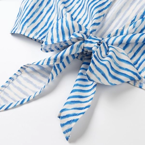 Detail of blue and white striped shirt featuring a stylish front tie-knot design