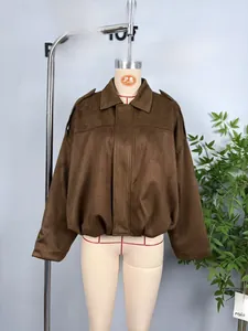 Close-up of brown suede bomber jacket featuring lapel collar and shoulder straps on mannequin