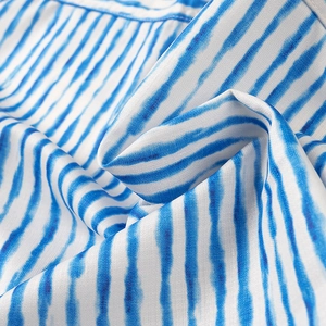 Detailed view of blue and white watercolor striped fabric texture with soft drapery