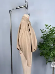 Detailed side view of khaki faux suede short jacket with ribbed hem on a mannequin