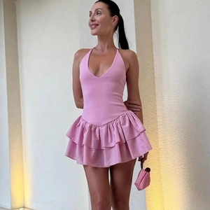 Detailed view of pink halter V-neck mini dress with tiered ruffle hem and open back design