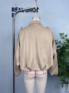 Detail of camel faux suede jacket showing back seams and elastic hem on mannequin