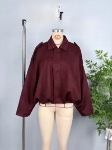 Detail of burgundy faux suede jacket featuring shoulder tabs and elasticated waist hem