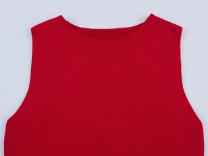 Close-up detail of red sleeveless dress featuring premium ribbed knit texture and stitching