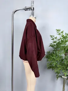 Detail view of burgundy utility jacket with drop shoulder design and elastic cuffs