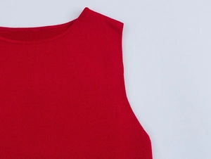 Close-up of the round neckline and smooth knit texture of this red sleeveless summer dress
