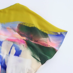 Detailed view of colorful abstract print fabric with fine stitching for midi dress