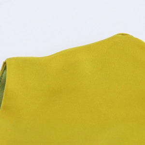 Close-up of lemon yellow twill fabric showing detailed weave texture of the sleeveless dress