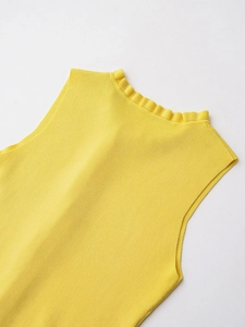 Detail of yellow sleeveless knit top featuring ruffled neckline and ribbed texture