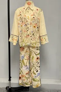 Detail of floral print pajama set featuring long-sleeved button-down top and matching pants
