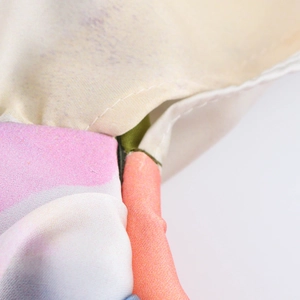 Detailed close-up showing high-quality stitching and colorful print on sleeveless midi dress