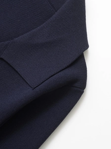 Close-up of navy blue knitted texture and fine stitching on a casual women blazer