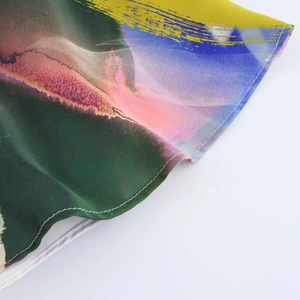 Macro view of abstract art print fabric with high-quality rolled hem sewing details