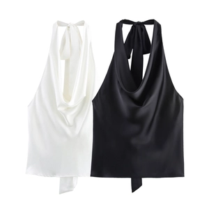 Detail of elegant cowl neck satin halter tops in black and white with silky texture