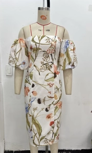 Detail of white floral off-shoulder midi dress with vintage botanical print and bubble sleeves