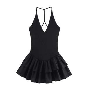 Detail of black halter dress with deep V-neck, cross back straps and layered ruffle hem