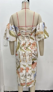 Detail of floral midi dress featuring a criss-cross lace-up back and bubble sleeves