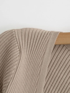 Detail of ribbed knit texture on oat-colored V-neck cardigan with shoulder stitching