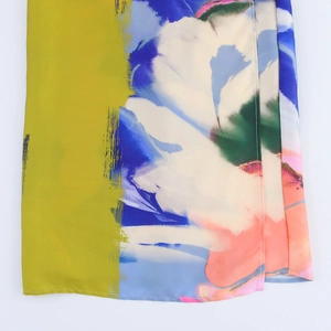 Detail of digital art print on summer dress with yellow and blue floral motifs