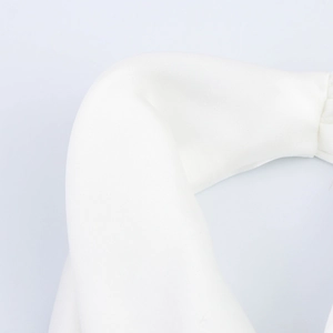 Macro shot of white satin padded headband showing smooth fabric texture and neat stitching