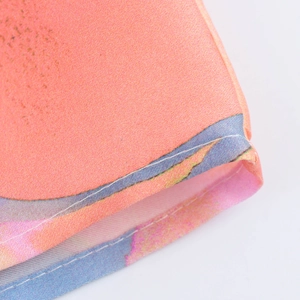 Macro detail of high-quality flat-seam edge on floral print satin midi dress