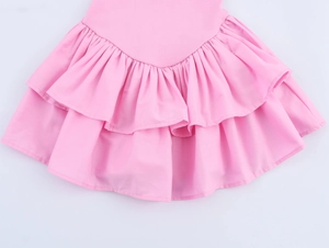 Detail shot of bright pink tiered ruffled hemline on sleeveless halter dress