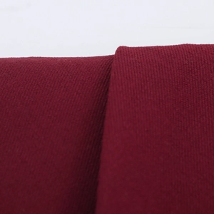 Macro view of the deep burgundy pleated fabric showing fine knitted texture and softness
