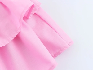Close-up detail of pink chiffon dress showing high-quality stitching and ruffle layers