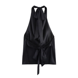 Detail of elegant black satin halter top featuring silky texture and bow tie back