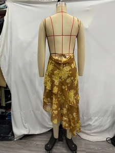 Detail of layered ruffle hem and floral chiffon fabric on a bohemian summer dress