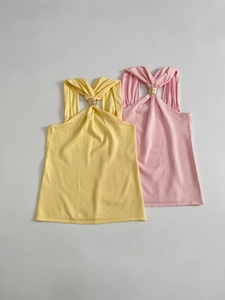 Detail of knitted halter tops with stylish twist knot and gold metal ring embellishment