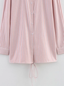 Detail of pink and white striped shirt featuring buttoned front and adjustable drawstring hem