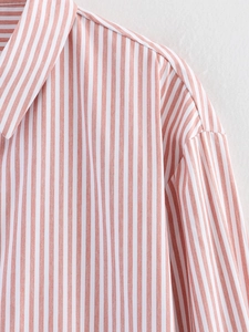 Detail view of pink and white striped shirt collar with dropped shoulder stitching