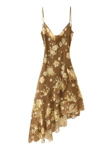 Detail of ruffled asymmetric hemline on brown floral chiffon sundress with high texture
