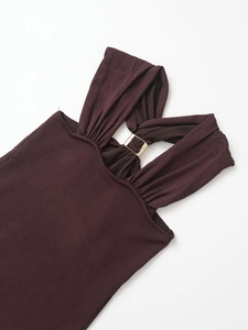 Detailed view of dark brown ribbed knit top featuring elegant gold hardware and draping