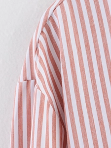 Detailed macro view of high-quality woven fabric texture and striped stitching on the shirt