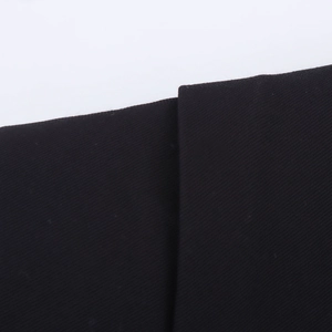 Macro shot of high-quality black twill fabric texture and stitching detail on the dress