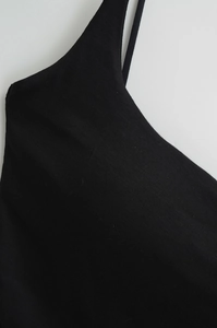 Close-up detail of black ribbed knit camisole top with thin shoulder straps