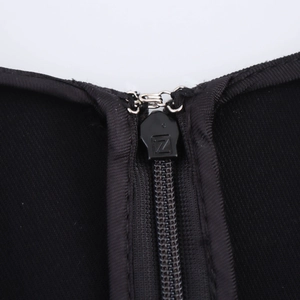 Detail of high-quality black nylon zipper and metal hook closure on midi dress