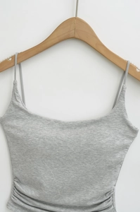 Detailed close-up of light grey slim-fit tank top with side ruching and thin straps