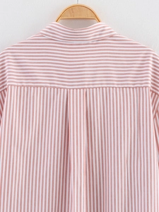 Detail of red striped shirt back yoke with horizontal stripes and wooden hanger display